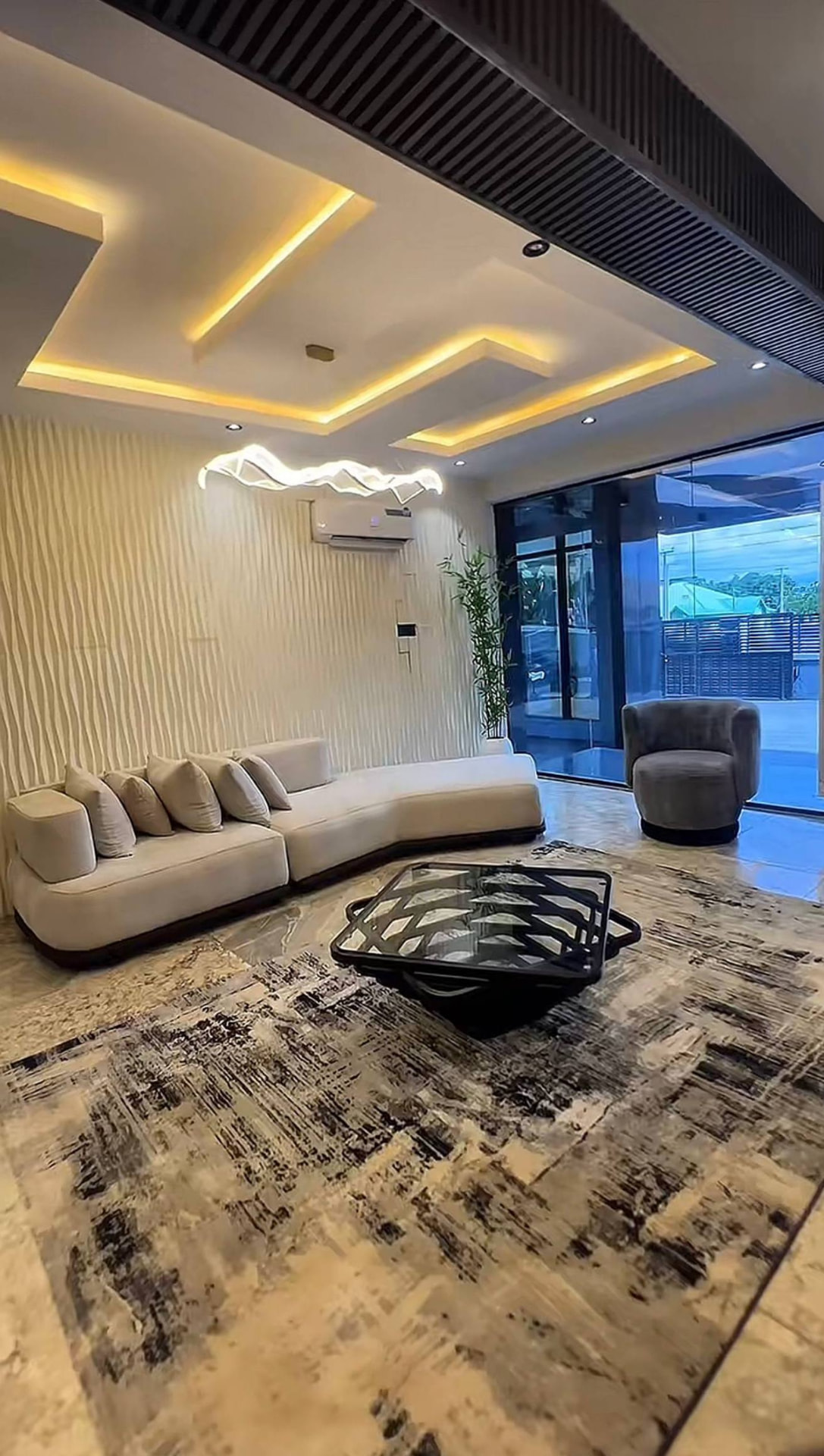 Lounge seating beside the glass façade at GAIA HOTELS & SUITES